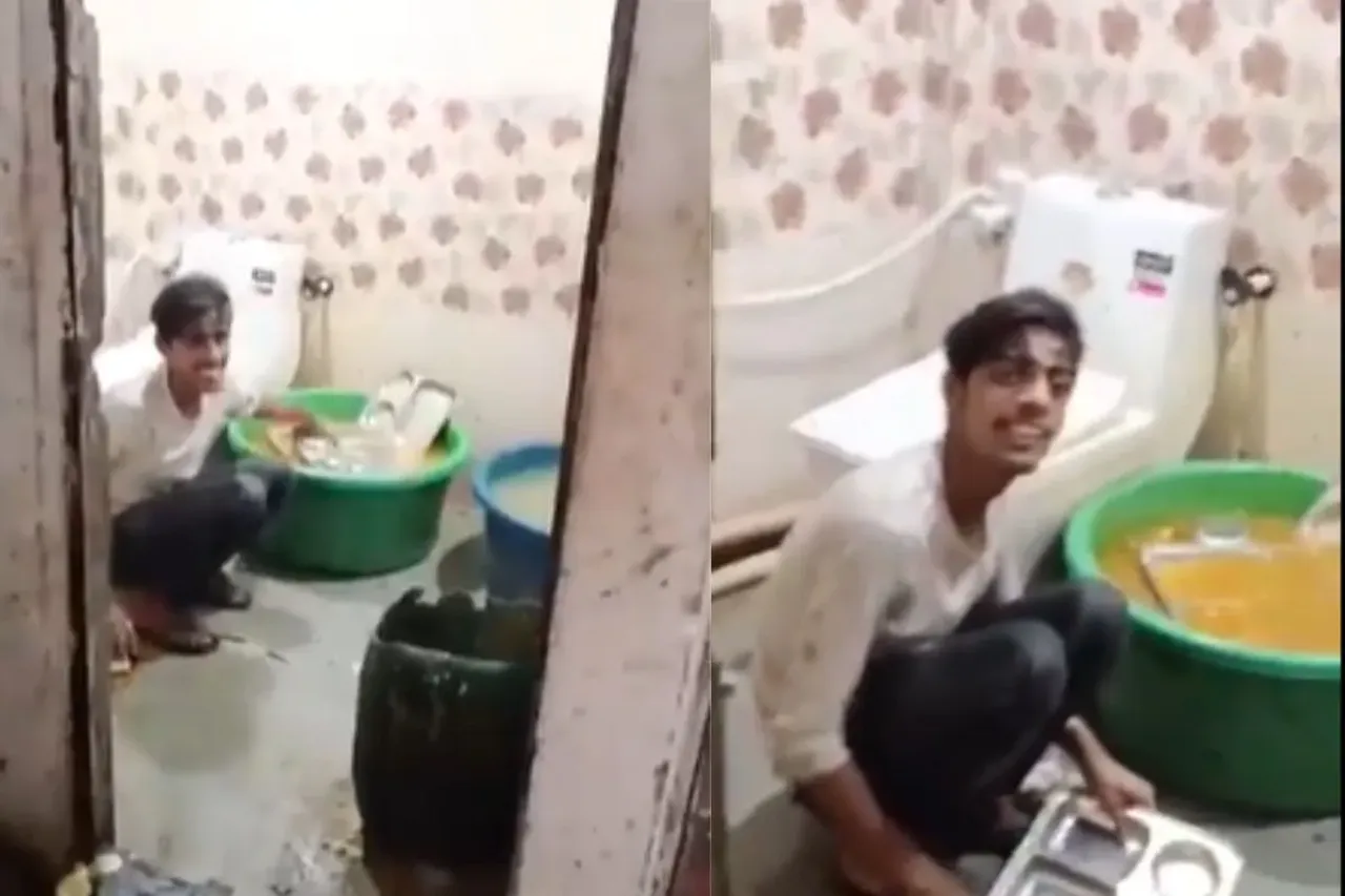 A worker washing restaurant dishes in a toilet