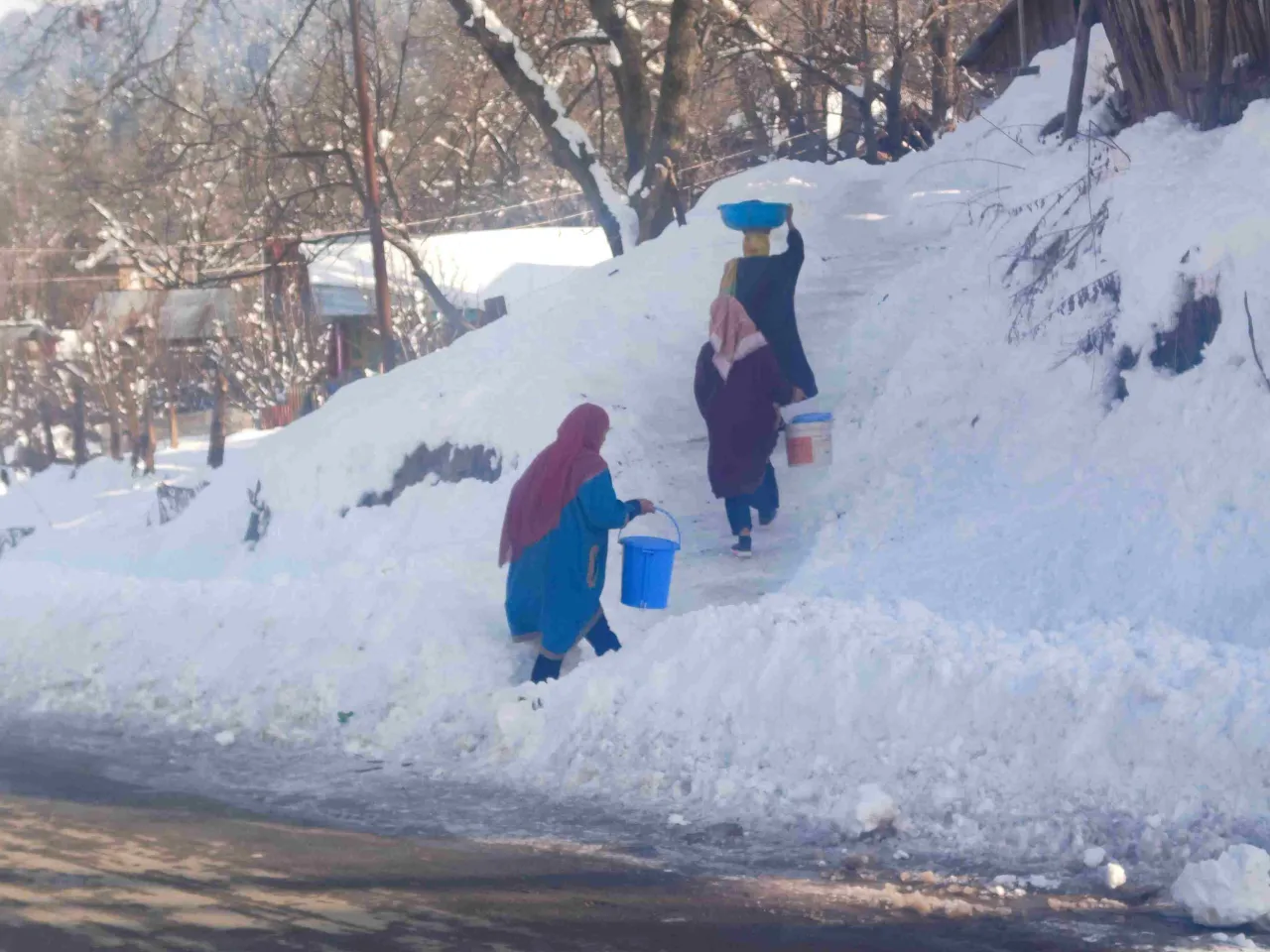 Women-collecting-water-from-a-running-stream-as-water-pipes-are-frozne-during-winters_11zon-1740887202 (1)