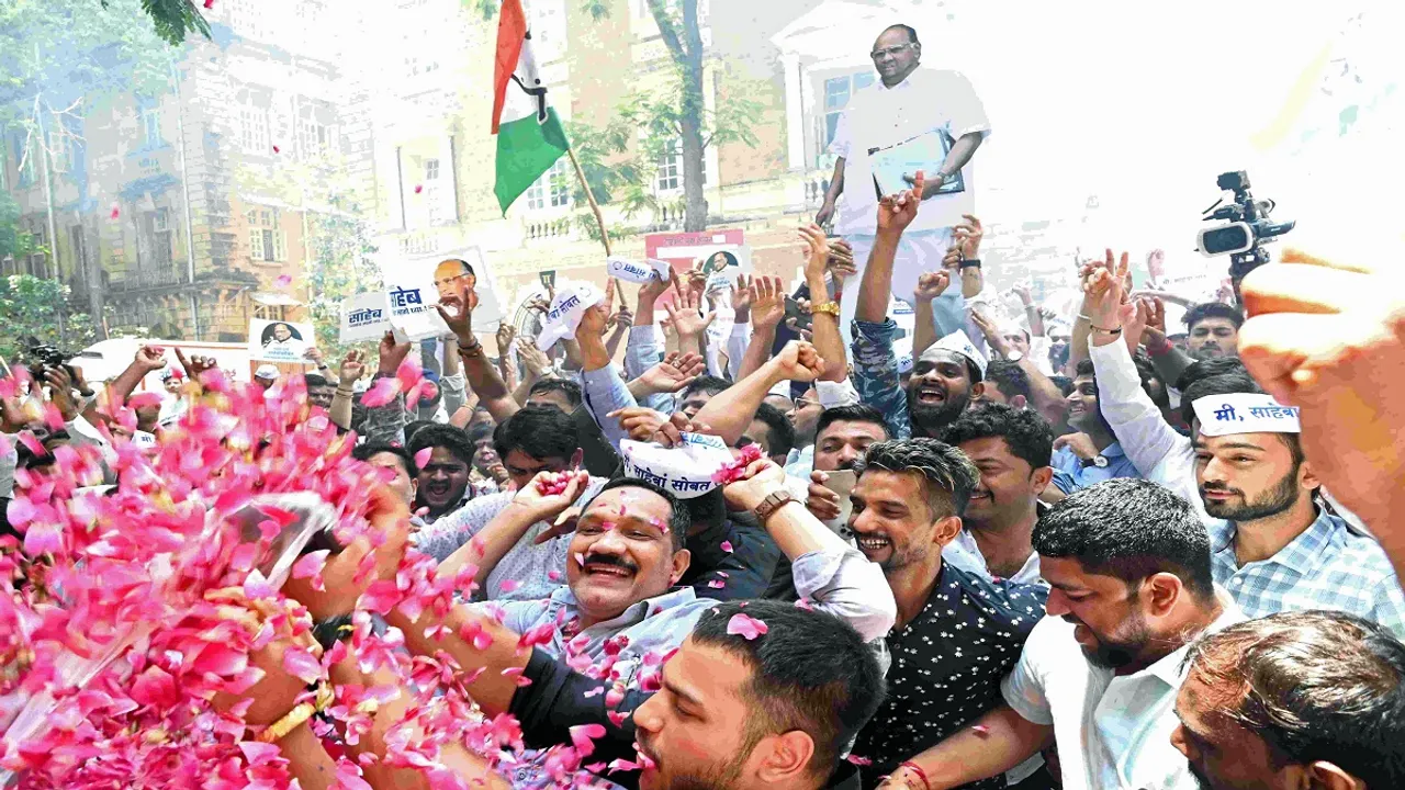 NCP supporters celebrate after party's core committee reject the resignation of Sharad Pawar as party president