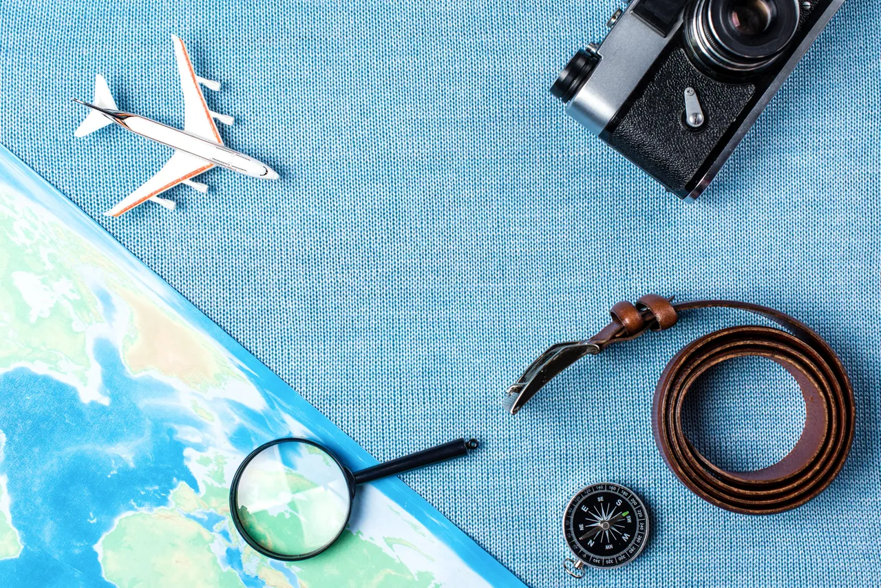 travel-accessories-on-blue-knitted-background-tra-2024-10-18-08-48-22-utc (1)