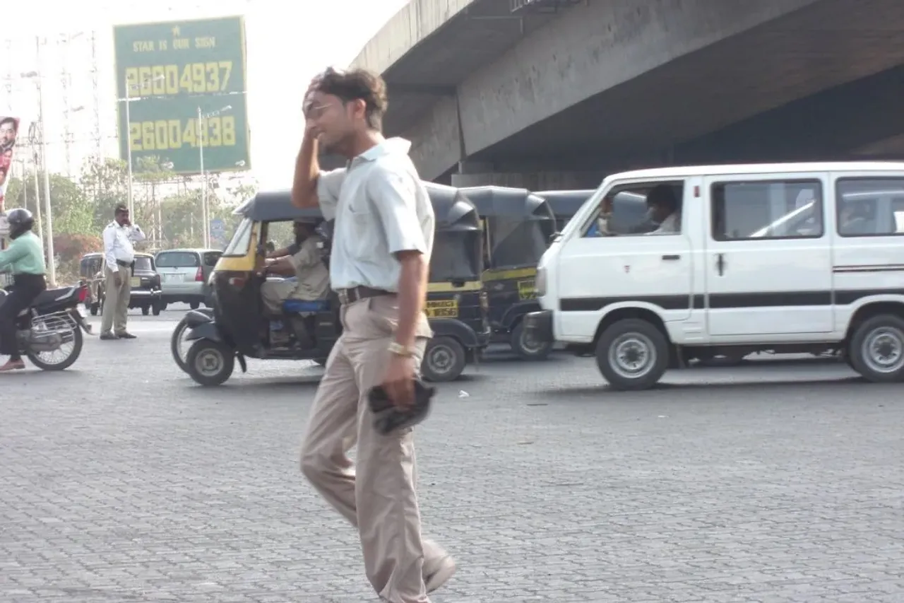 A  man walking under the scorching sun at Bandra Sion link Signal, signaling the onset of summer with the heat wave