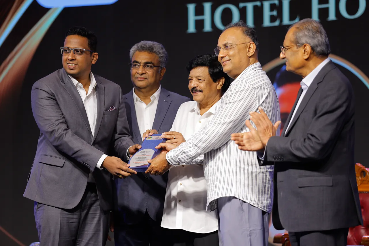 Mr. Victor Rage receiving the Housekeeper of the Year award