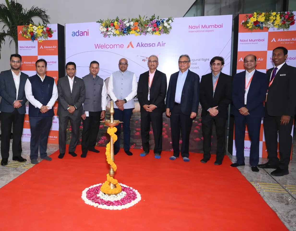 Vinay Dube, Founder and CEO, Akasa Air, and Arun Bansal, Chief Executive Officer, Adani Airports Holding Ltd, with senior officials from Akasa Air and Navi Mumbai International Airport, at the lamp-lighting ceremon