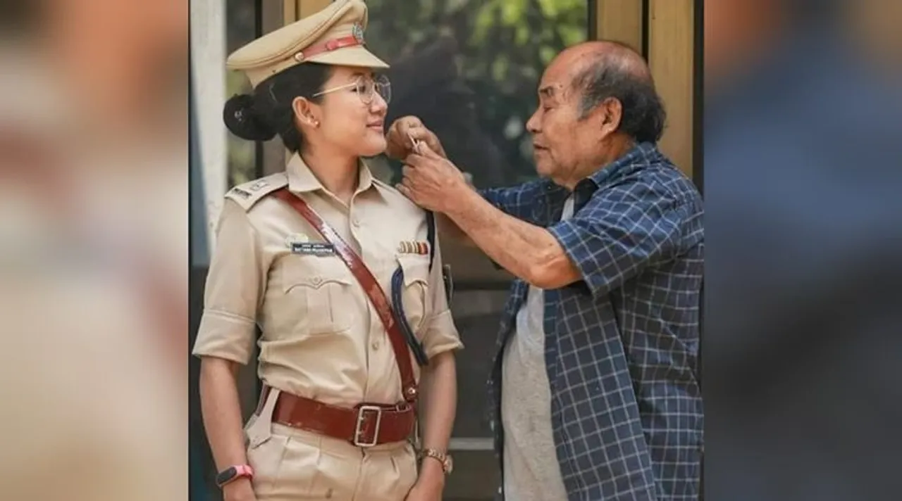 father checks star on daughter uniform
