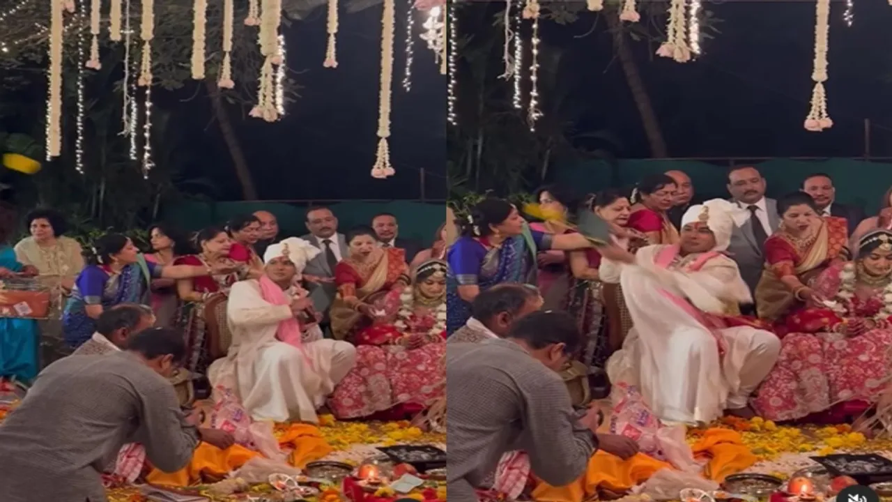 The groom started playing cricket in the mandap by diverting attention from the bride- दुल्हन से ध्यान हटाकर मंडप में क्रिकेट खेलने लगा दूल्हा, The groom was seen busy in cricket before preparing for the rounds in the mandap- मंडप में फेरे की तैयारी से पहले क्रिकेट में मशगूल दिखा दूल्हा, Friends bowled with flowers and the groom sitting in the pavilion did amazing batting- दोस्तों ने फूल से की बॉलिंग तो मंडप में बैठे दूल्हे ने की कमाल की बैटिंग, The groom was sitting in the mandap with the bride then started playing cricket with friends- दुल्हन के साथ मंडप में बैठा था दूल्हा तभी दोस्तों संग खेलने लगा क्रिकेट, Friends made the flower a ball, then the groom started batting with the tablet- दोस्तों ने फूल को बनाया बॉल तो दूल्हा टैबलेट से करने लगा बैटिंग, Groom's love for cricket was seen amidst wedding rituals- शादी की रस्मों रिवाज के बीच देखने को मिला दूल्हे का क्रिकेट प्रेम, AJAB GAJAB NEWS, KHABRE JARA HATKE, VIRAL NEWS, OMG, WEIRD NEWS