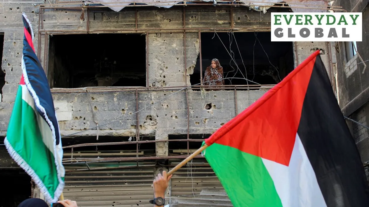A woman looks on as Syrians gather during a pro-Palestinian protest to express solidarity with Palestinians in Gaza, in Yarmouk Palestinian refugee camp, near Damascus, Syria, October 20, 2023