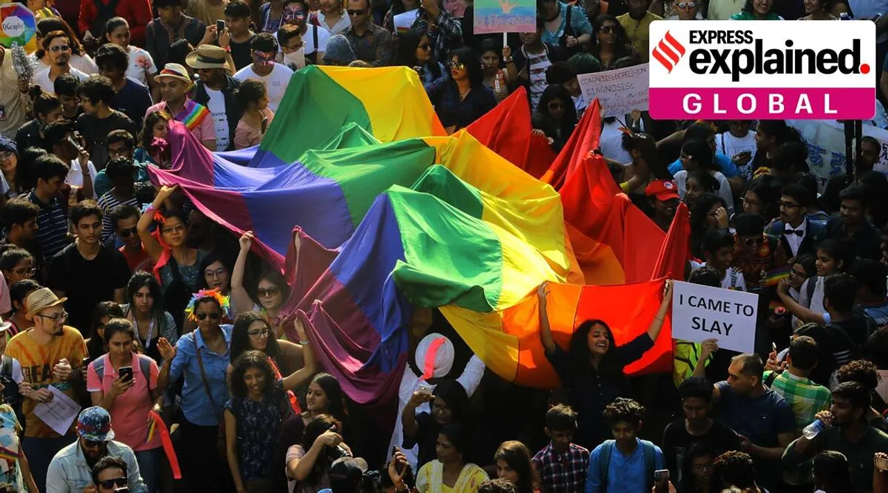 Supporters of LGBTQ community holding the Pride flag during the Queer Azadi pride march at Grandroad. (Express Photo by Vignesh Krishnamoorthy)