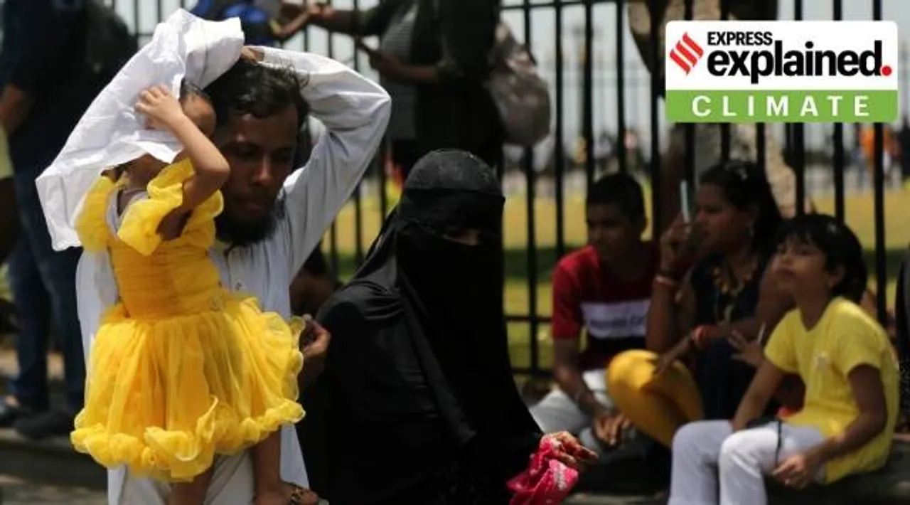 A family tries shielding from the sun in Mumbai, Maharashtra. (Express Photo By Ganesh Shirsekar, File)
