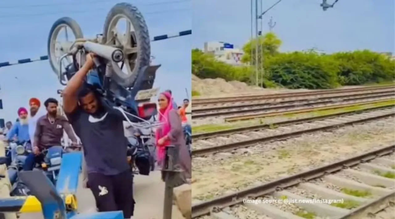Man lifts bike railway track