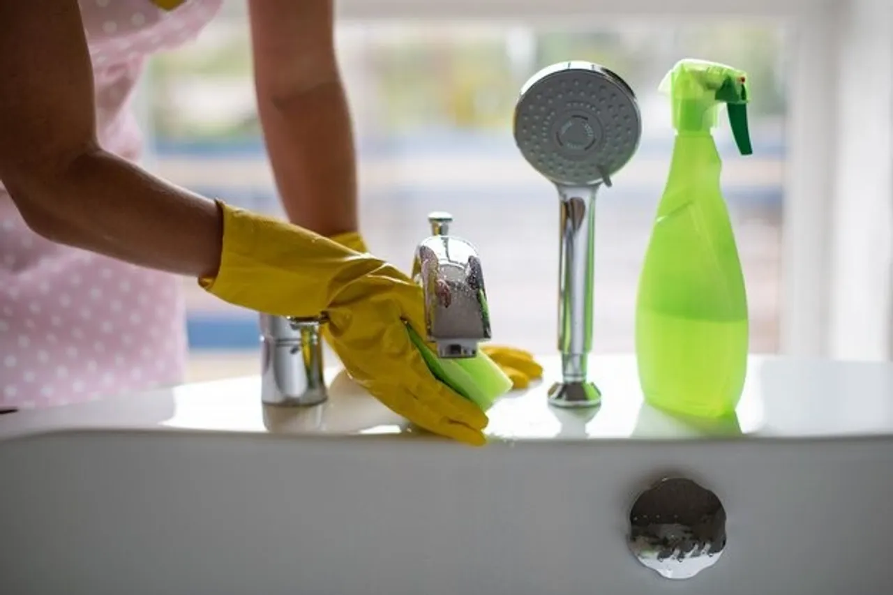 cleanliness-hygiene-home-hand-green-yellow-rubber-gloves-rubbing-bathroom-taps_1048944-19984006