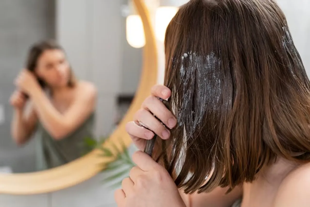 young-woman-applying-anti-dandruff-product_23-2149345800