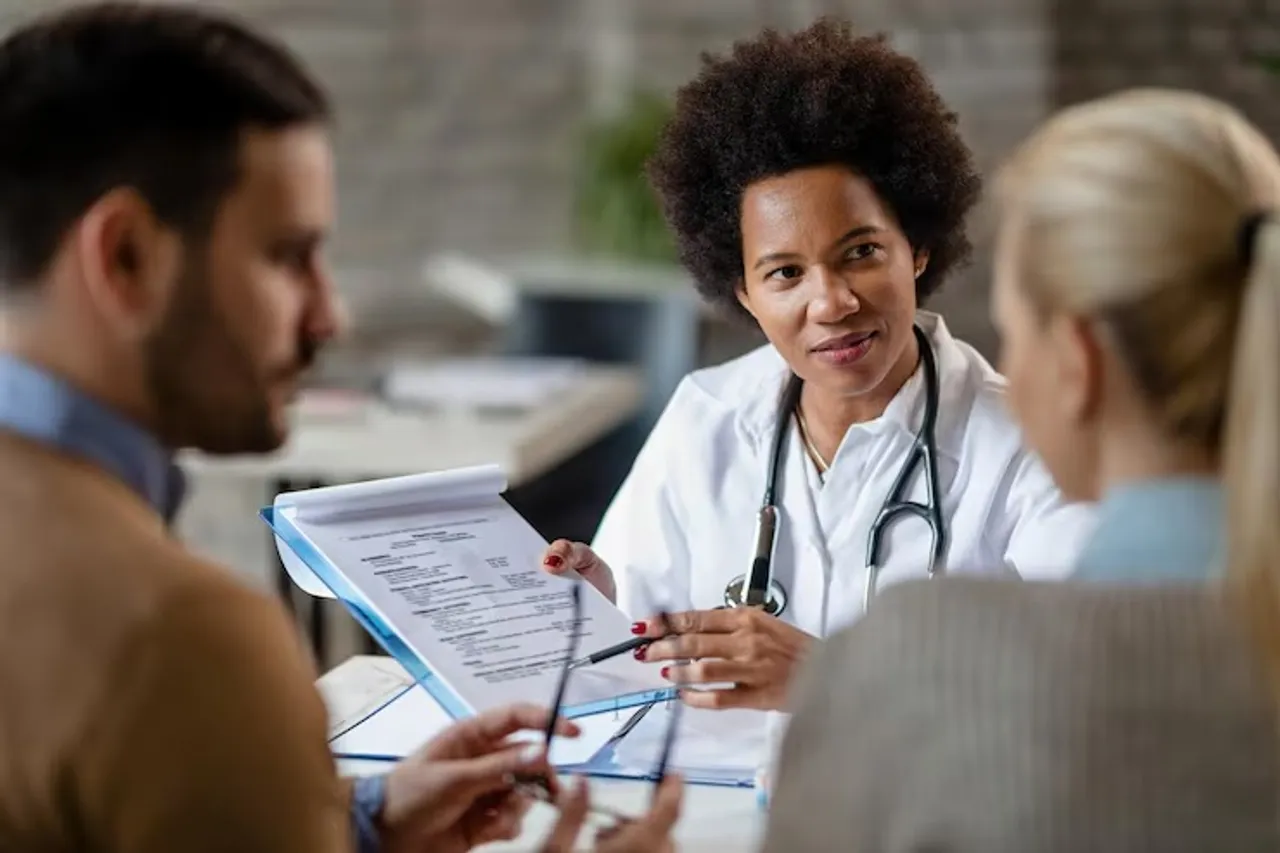 african-american-female-doctor-showing-couple-test-results-their-medical-exam-clinic_637285-1158