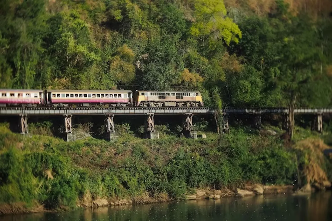 railroad-tracks-by-river-amidst-trees_1048944-15739217