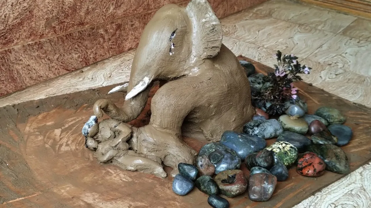 An elephant guarding grandmother and granddaughter in Wayanad