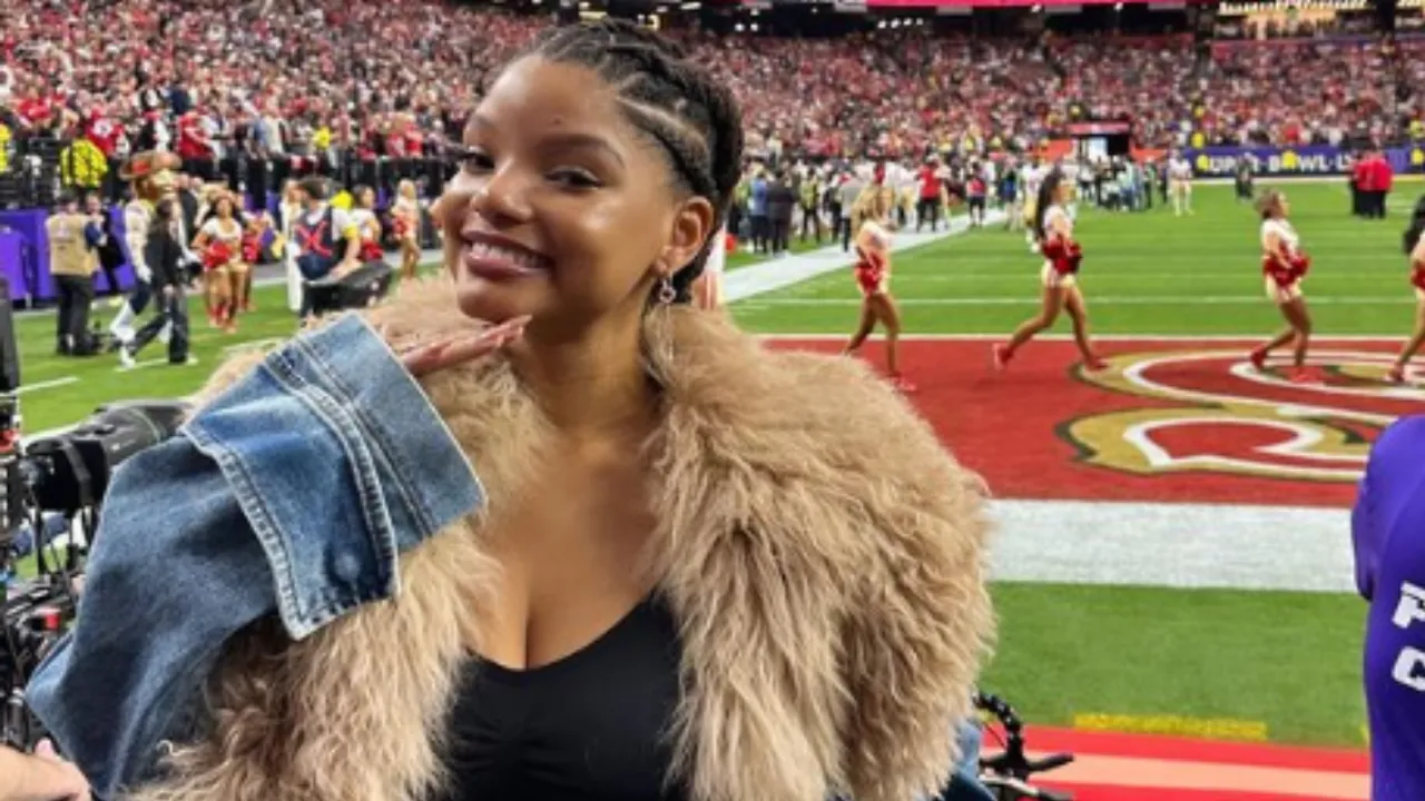 Halle Bailey Attends Super Bowl 2024 in Crop Top and Jeans