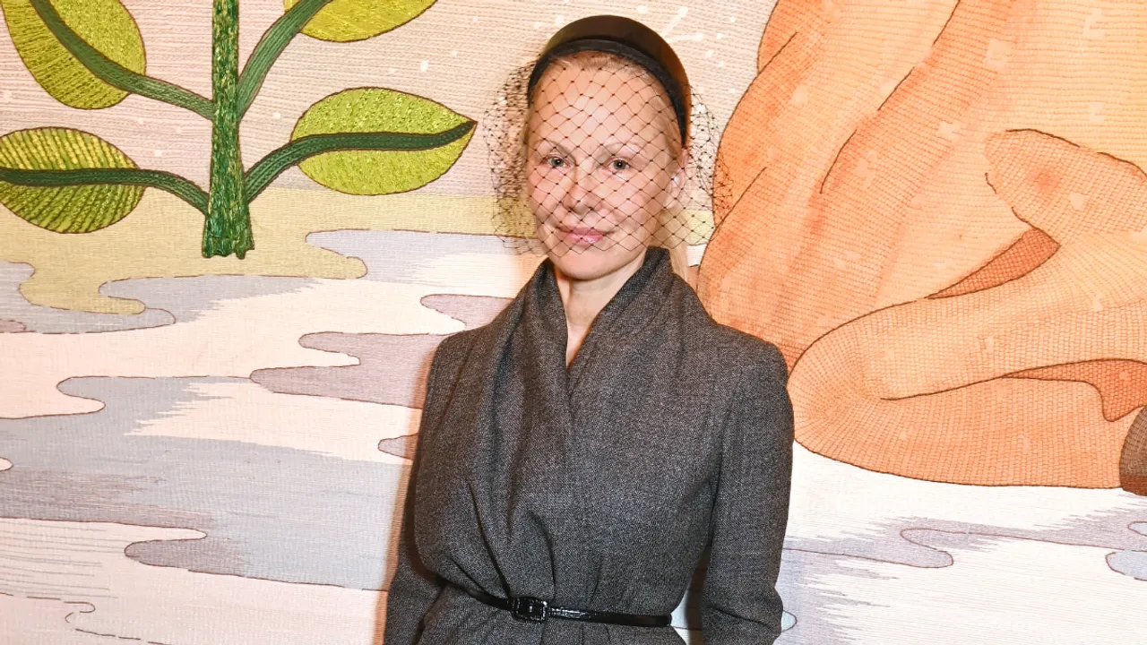 Pamela Anderson Shines Barefaced in Retro Veiled Headband at Dior Paris Fashion Week