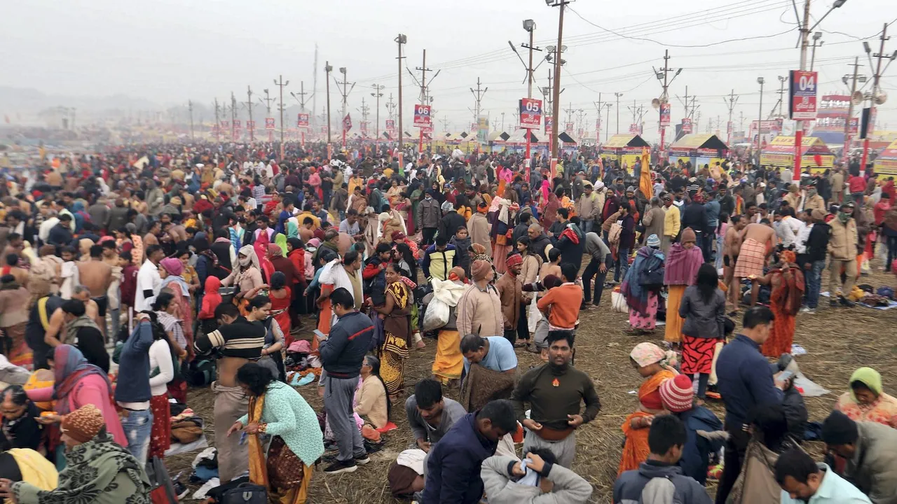 Devotees gather to take holy dip in the waters of Sangam, the confluence of the Ganges, Yamuna and Saraswati rivers, on the occasion of Makar Sankranti during Magh Mela in Prayagraj on Sunday