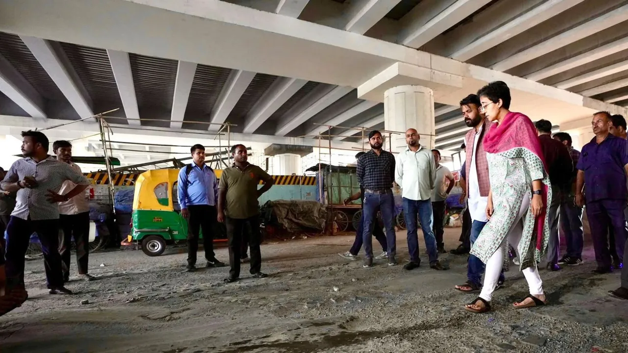 Delhi Chief Minister Atishi inspects condition of a road, in New Delhi, Tuesday, Oct. 1, 2024.