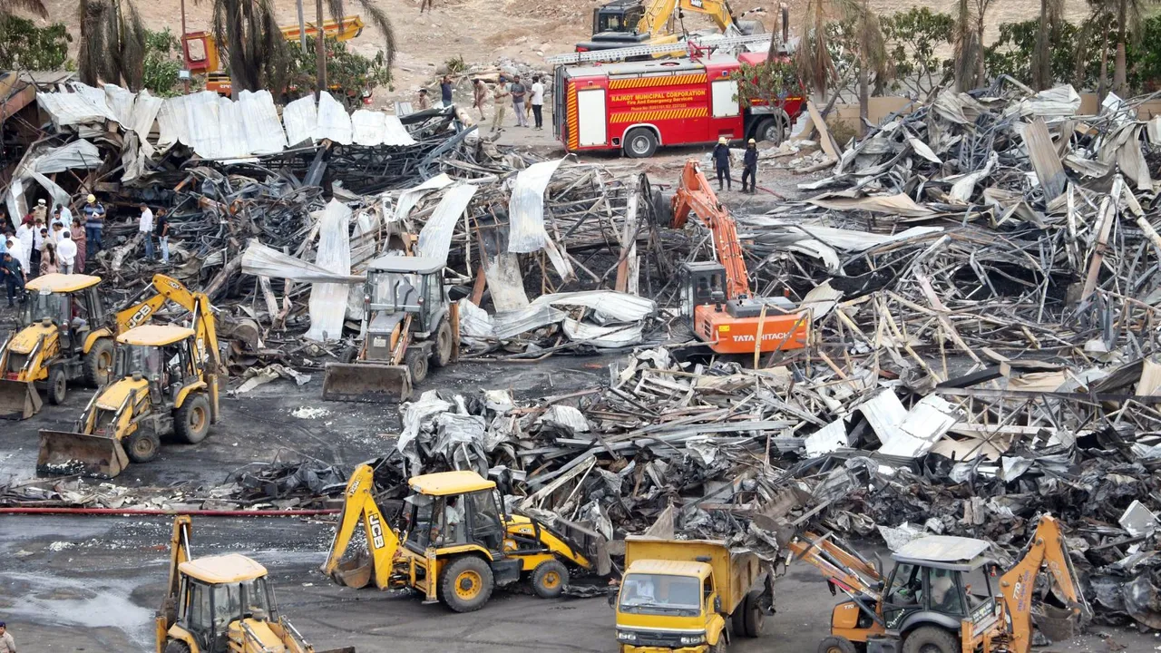 Debris being removed from the game zone site where a major fire on Saturday evening killed at least 27 people and injured three, in Rajkot, Sunday, May 26, 2024
