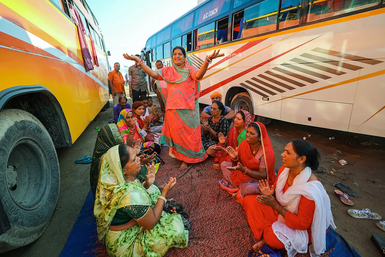 Stranded pilgrims wait for the resumption of the Amarnath Yatra near a base camp, in Jammu, Tuesday.jpg