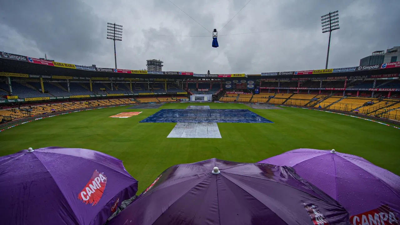 The pitch covered during rains on the first day of the first test cricket match between India and New Zealand at M Chinnaswamy Stadium, in Bengaluru, Wednesday, Oct 16, 2024.