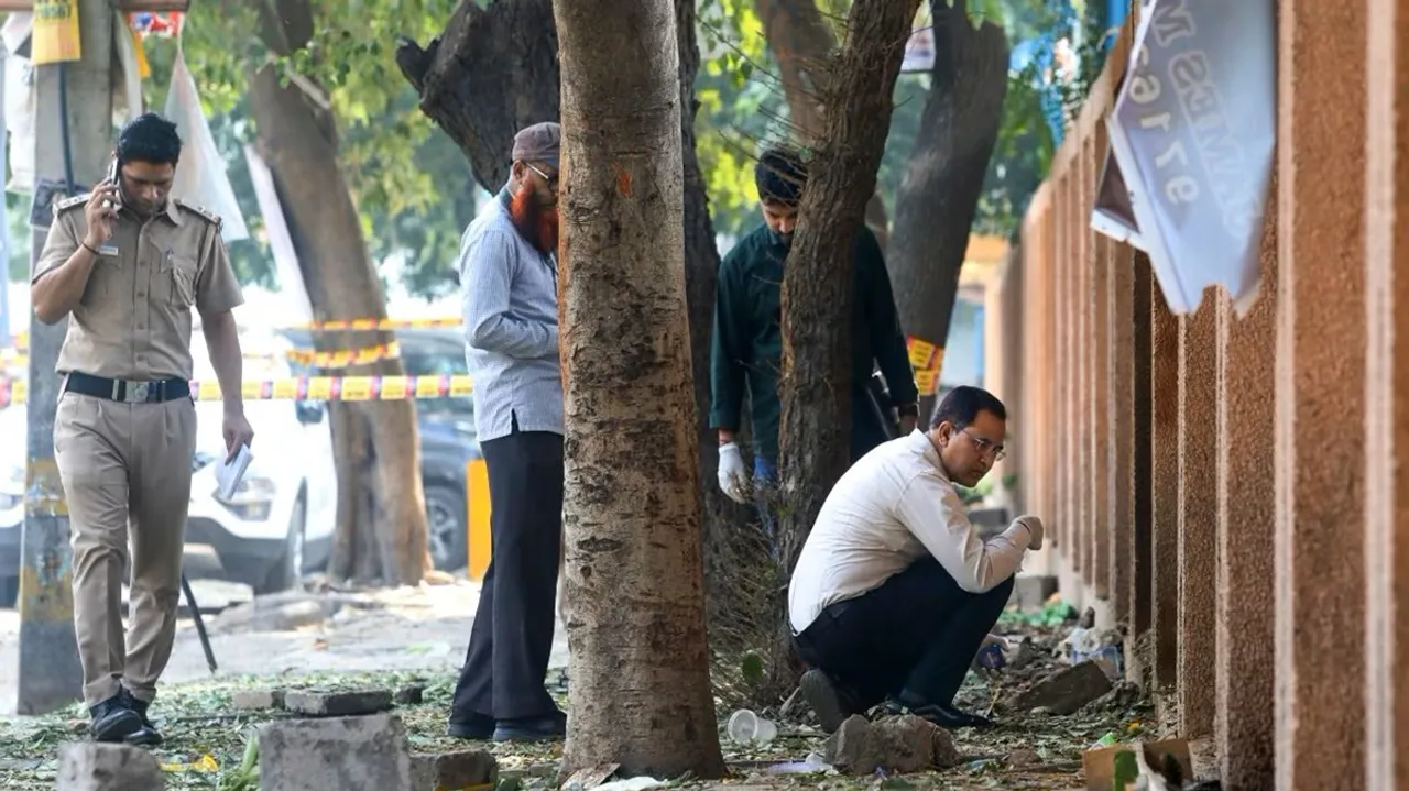 Forensic experts collect samples from the site after a blast was reported at Prashant Vihar, near CRPF school in Rohini area of New Delhi on Sunday