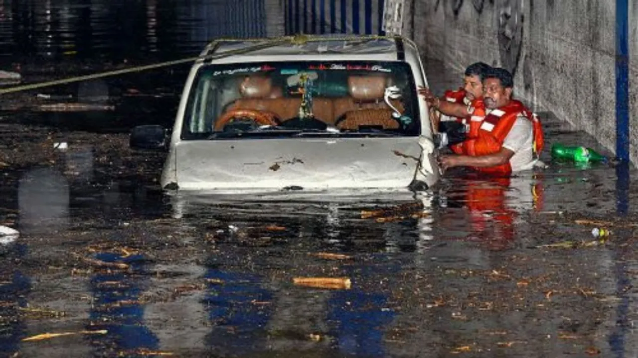 Rescue operation underway after a car got stuck in a waterlogged underpass following heavy rain, in Bengaluru.