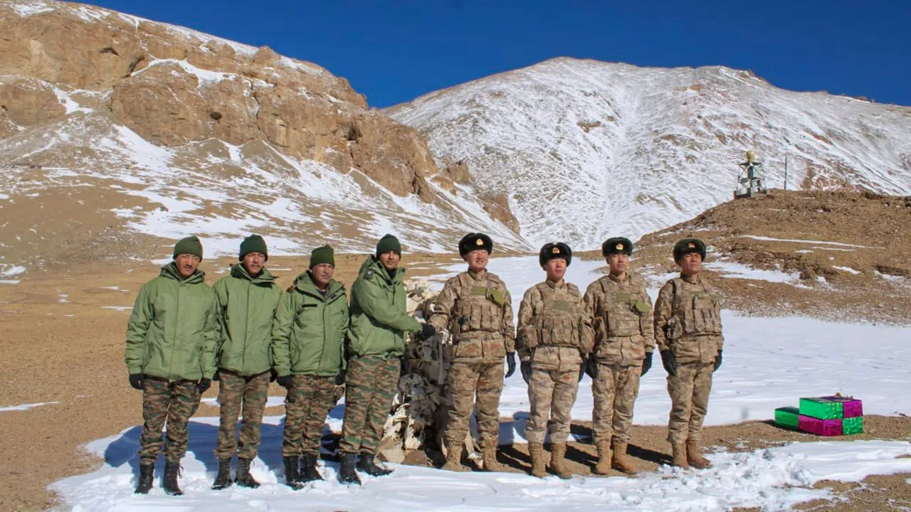 Indian and Chinese Army personnel exchange sweets on the Diwali festival, at the KK Pass.
