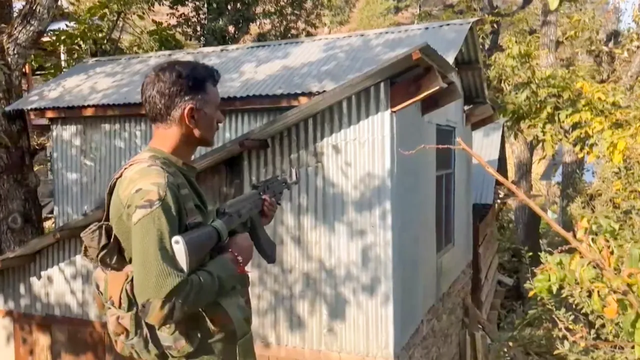 A security personnel during a search operation for the terrorists behind the killing of two Village Defence Guards, at Ohli village in Kishtwar district