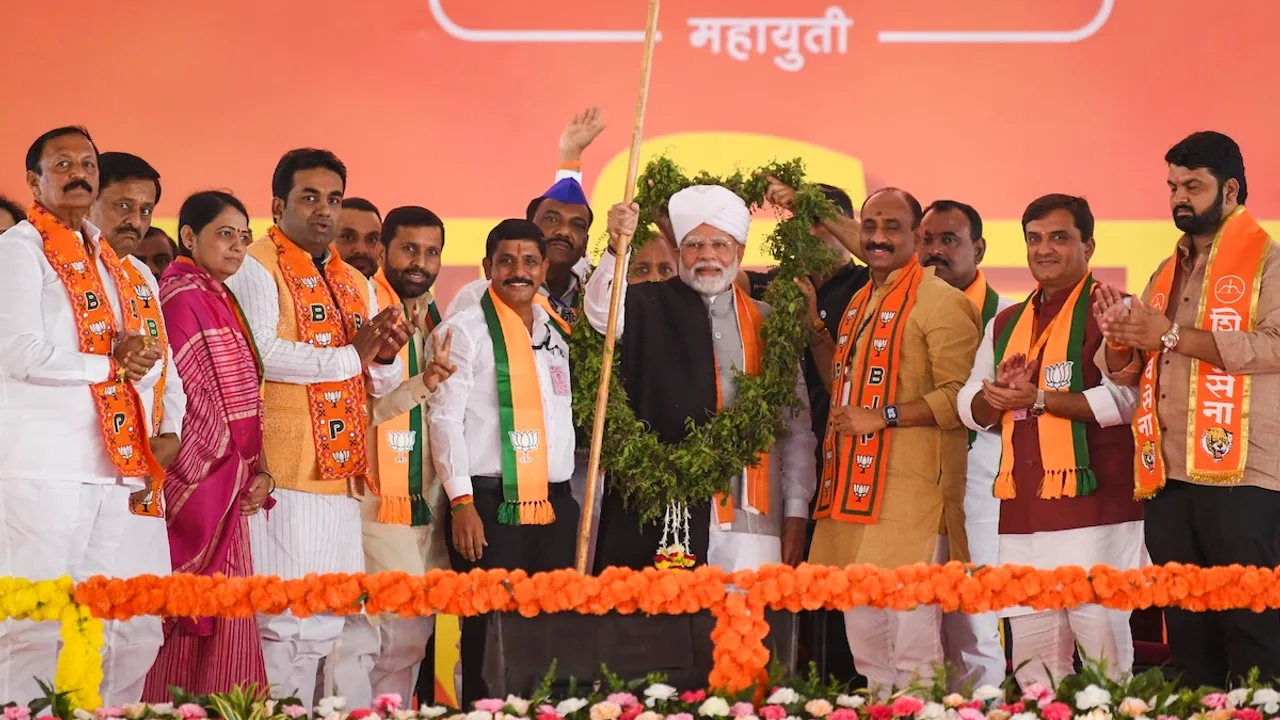 Prime Minister Narendra Modi being felicitated during a public meeting ahead of Maharashtra Assembly elections, in Solapur, Maharashtra, Tuesday, Nov. 12, 2024.