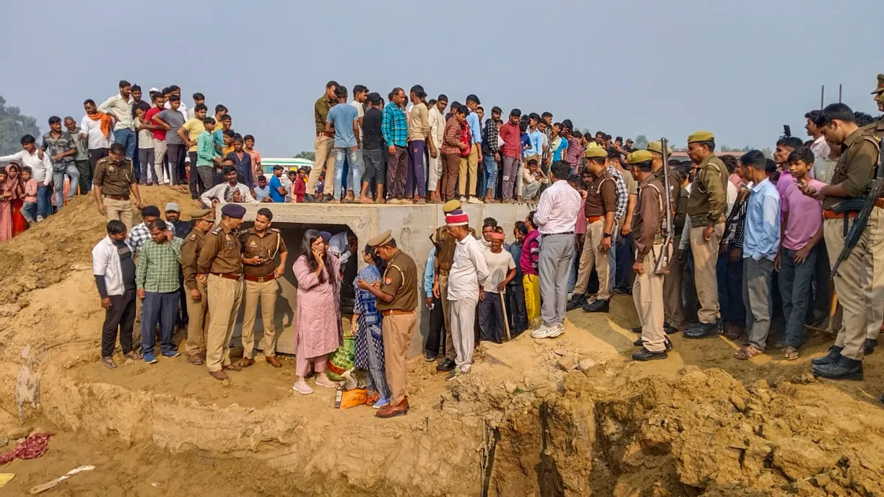 Police personnel conduct investigation as people gather after a mound of mud collapsed, in Kasganj, Uttar Pradesh, Tuesday, Nov 12, 2024