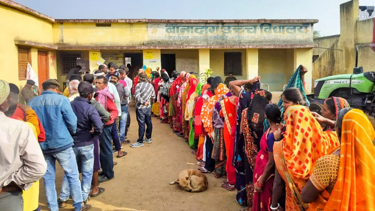 People wait to cast their votes for the first phase of Jharkhand Assembly election, in Hazaribagh district, Wednesday, Nov. 13, 2024.