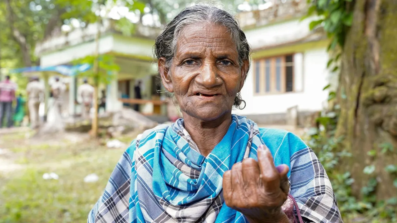 A tribal woman shows her ink-marked finger after casting her vote for the Wayanad Lok Sabha by-poll, Wednesday, Nov. 13, 2024.