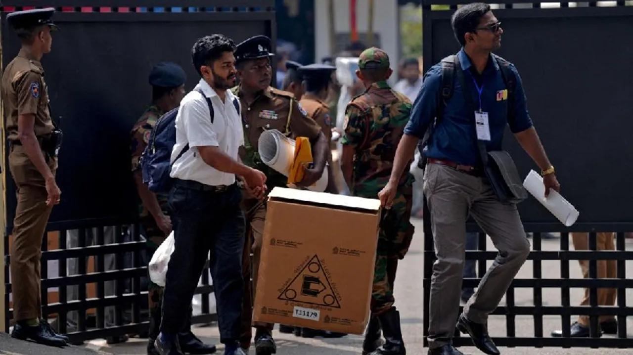 Polling officials and police officers carry election materials after collecting them from a distribution centre, a day before the Parliamentary Election, in Colombo, Sri Lanka, November 13, 2024.