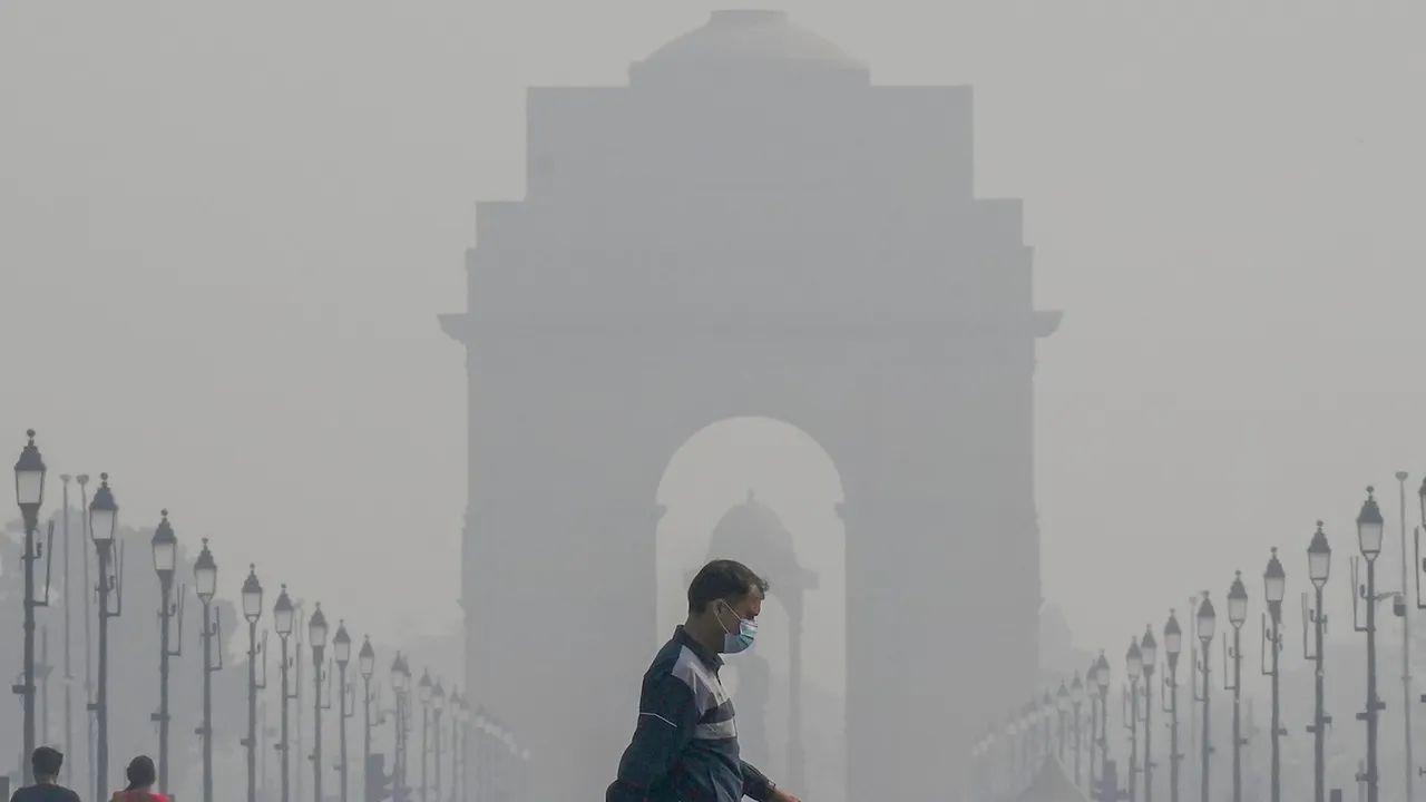 A pedestrian wearing a face mask at Kartavya Path as air quality continues to remain poor, in New Delhi
