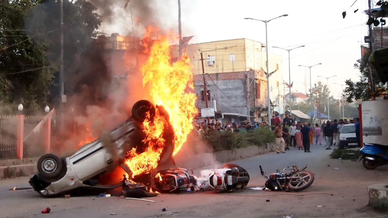 Smoke and flames billow out of vehicles which were set on fire during demonstrations after three bodies, suspected to be of six missing persons from Jiribam district, were found near the Manipur-Assam border on Friday night, in Imphal, Saturday, Nov. 16, 2024.