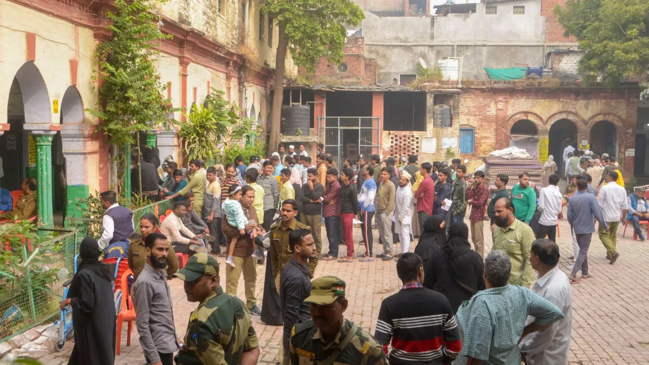 Voters waiting to cast votes at a polling booth during UP's Sishamau Assembly constituency bypoll, in Kanpur, Wednesday, Nov. 20, 2024.