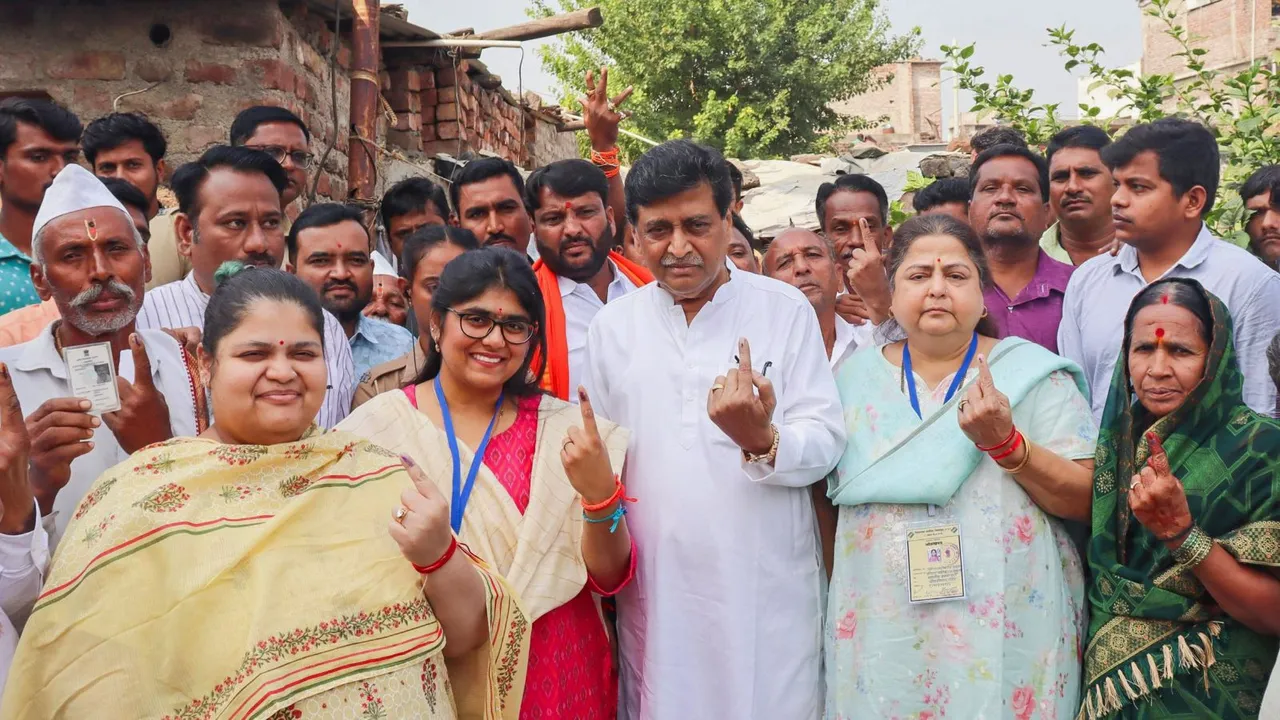 BJP leader Ashok Chavan with others shows his ink-marked finger after casting vote during the Maharashtra Assembly elections and Nanded Lok Sabha bypoll, in Nanded