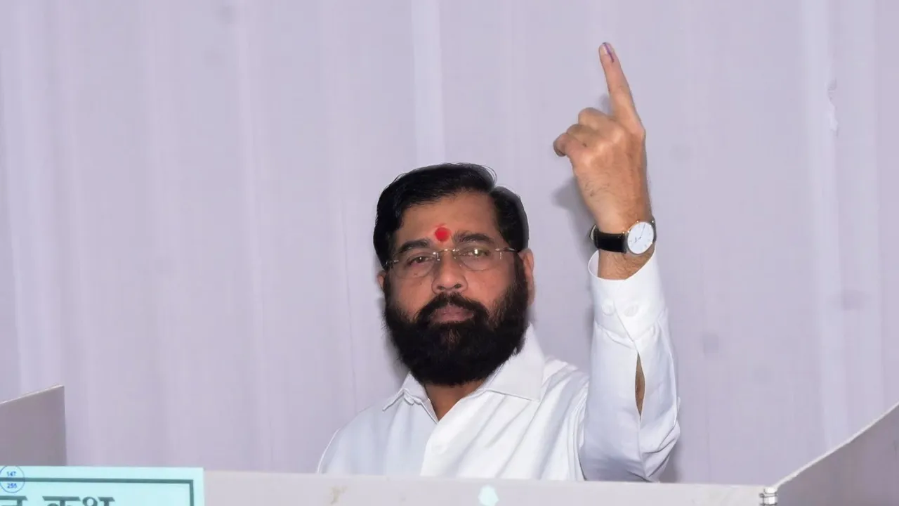 Maharashtra Chief Minister Eknath Shinde shows his ink-marked finger after casting vote during the state Assembly elections, in Thane, Maharashtra.