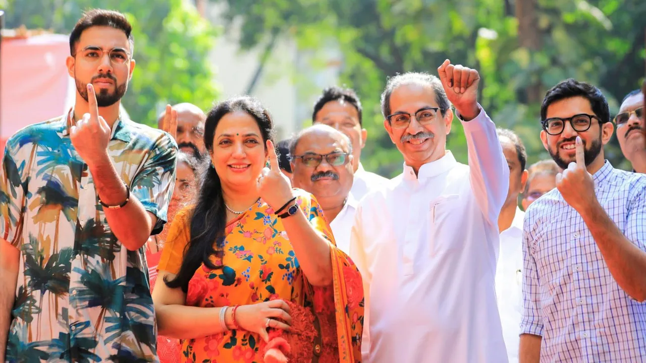 Shiv Sena (UBT) chief Uddhav Thackeray with his son Aaditya Thackeray and other family members shows his ink-marked finger after casting vote during the Maharashtra Assembly elections, in Mumbai, Wednesday, Nov. 20, 2024.