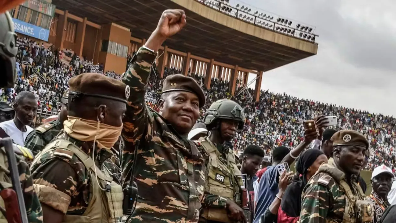 Gen Abdourahamane Tiani (second left), the head of the military regime in Niger, greets a crowd in Niamey in July 2024. Boureima Hama