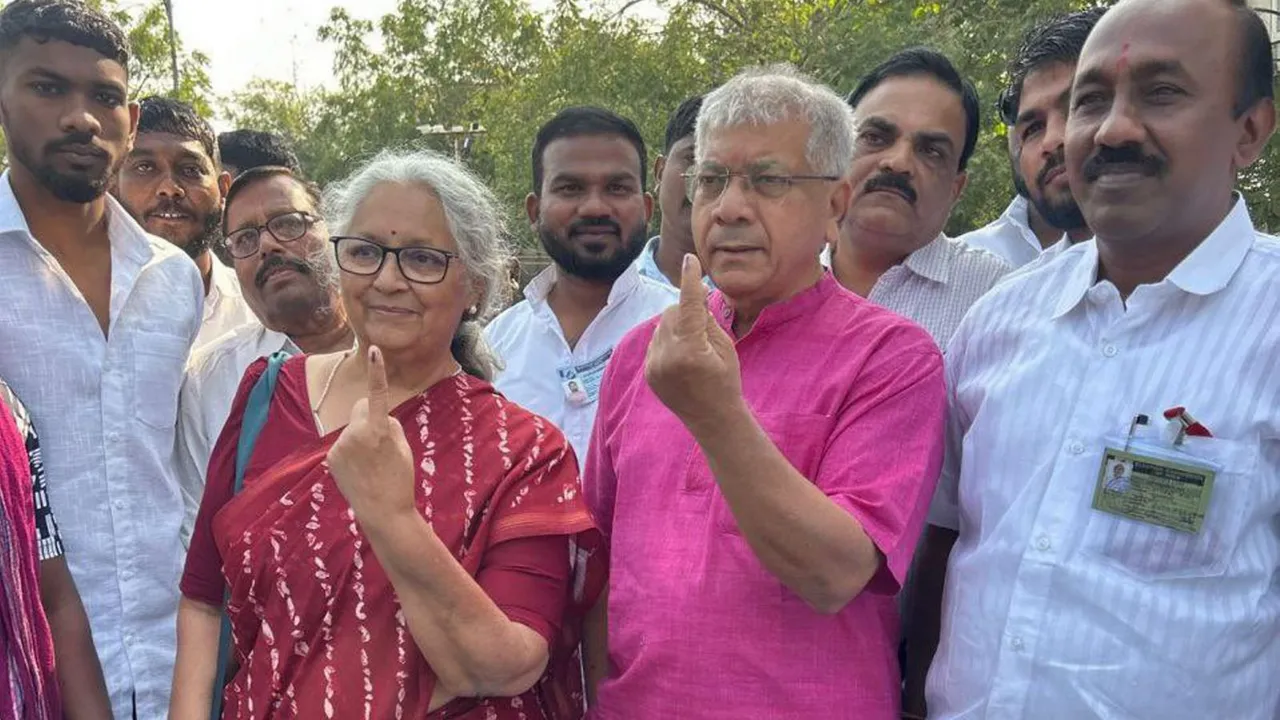 Vanchit Bahujan Aaghadi President Prakash Ambedkar and his wife show their fingers marked with indelible ink after casting votes during the Maharashtra Assembly elections, in Akola district, Wednesday, Nov. 20, 2024.