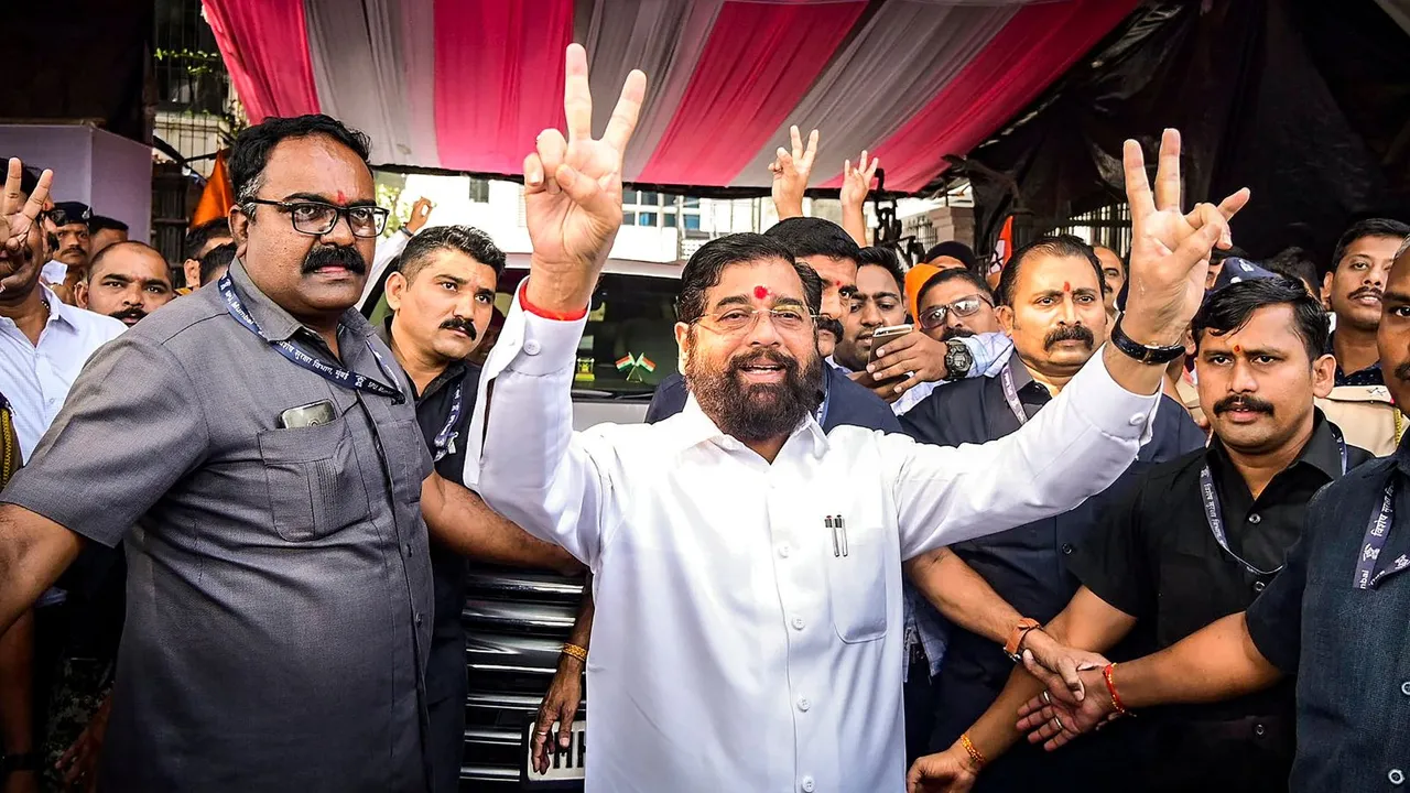 Maharashtra Chief Minister Eknath Shinde with supporters flashes victory signs as the BJP-led Mahayuti alliance leads amid the counting of votes for the Maharashtra Assembly elections, in Thane.