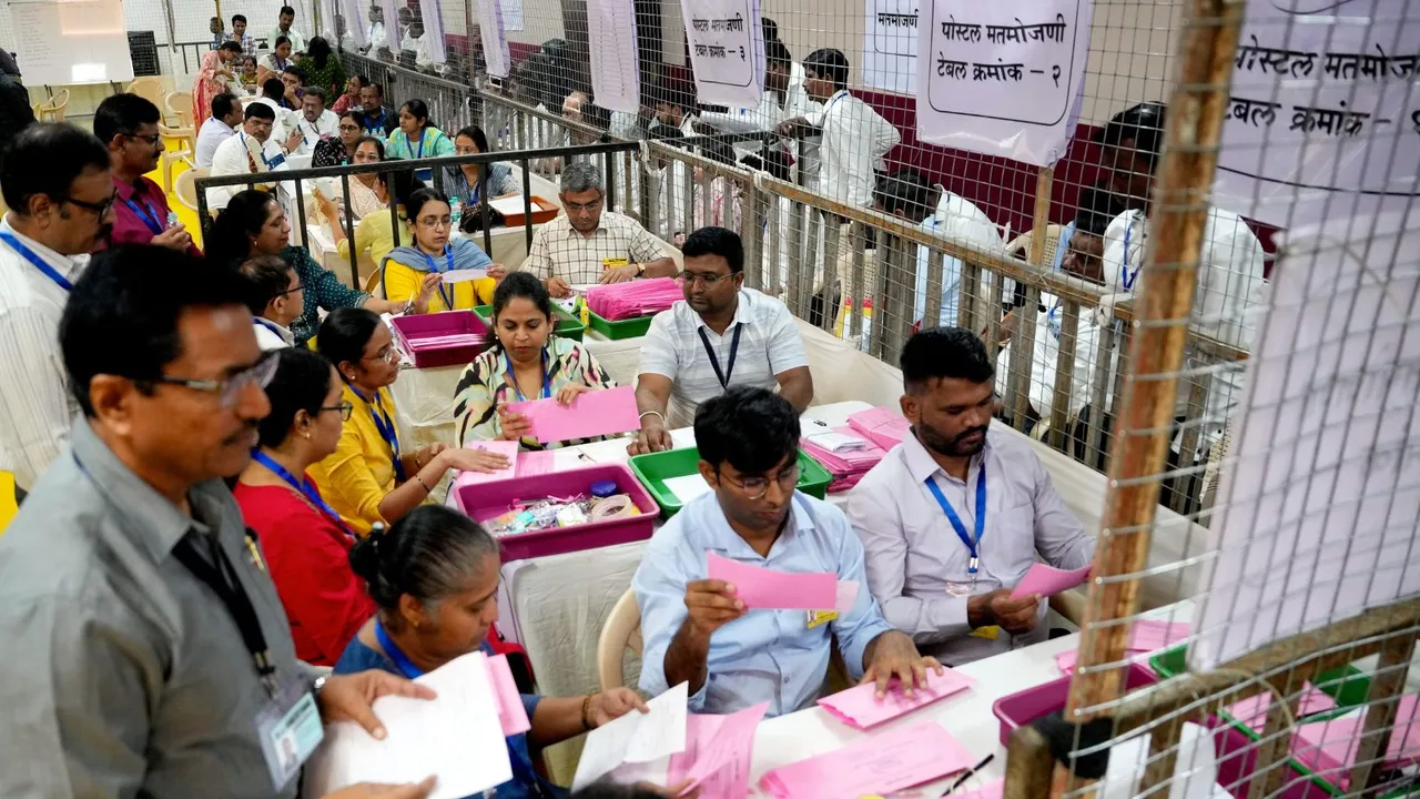 Polling officials at a counting center amid the counting of votes for the Maharashtra Assembly elections, in Mumbai, Saturday, Nov. 23, 2024.