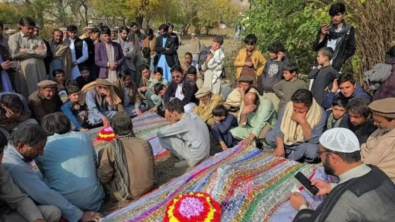 People mourn over the graves of relatives who were killed after gunmen opened fire on passenger vehicles in the Kurram tribal district of Khyber Pakhtunkhwa province, in Shalozan, Pakistan November 22, 2024