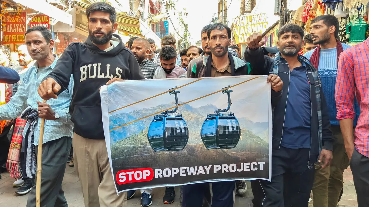 People take part in a protest march during the fourth day of a strike against a proposed ropeway project along the trek route to the Vaishno Devi shrine, at Katra in Reasi district, Jammu & Kashmir, Monday, Nov. 25, 2024.