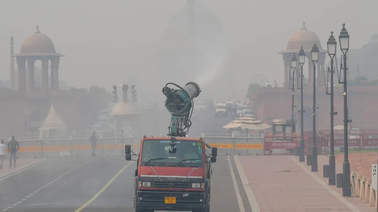 An anti-smog gun sprays mist to mitigate smoggy conditions, in New Delhi