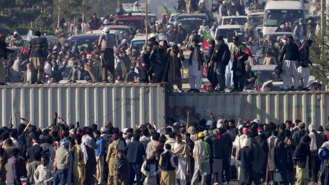 Supporters of imprisoned former premier Imran Khan's Pakistan Tehreek-e-Insaf party, remove shipping container to clear way for their rally demanding Khan's release, in Islamabad, Pakistan
