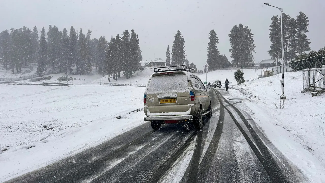 Vehicles move on a road amid light snowfall, in Gulmarg, Sunday, Dec. 8, 2024.