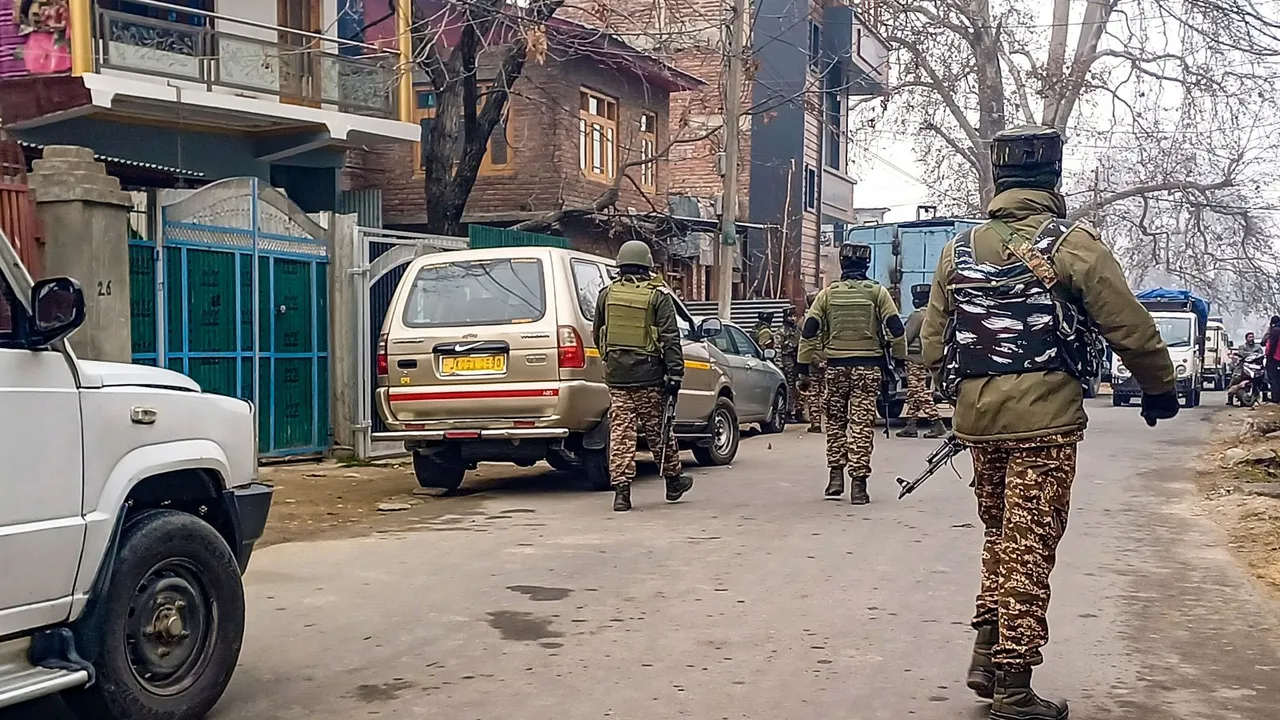 Security forces personnel guard as NIA conducts raids at a locationn in a terror funding case, in Anantnag, Thursday, Dec. 12, 2024.